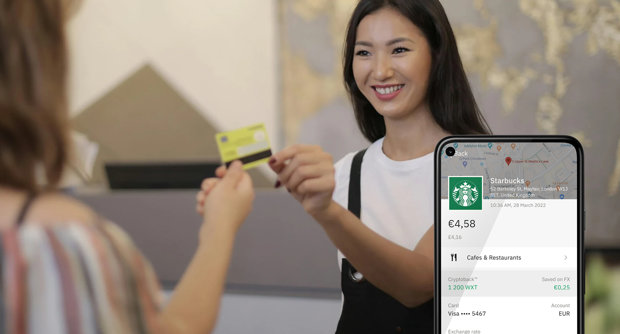 A smiling Starbucks employee with phone overlay of a Starbucks payment screen