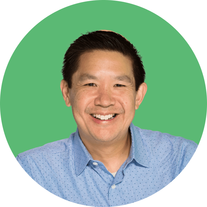 David Chan in front of a green background.