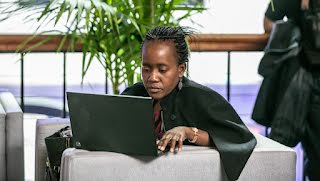 A woman is working on laptop.