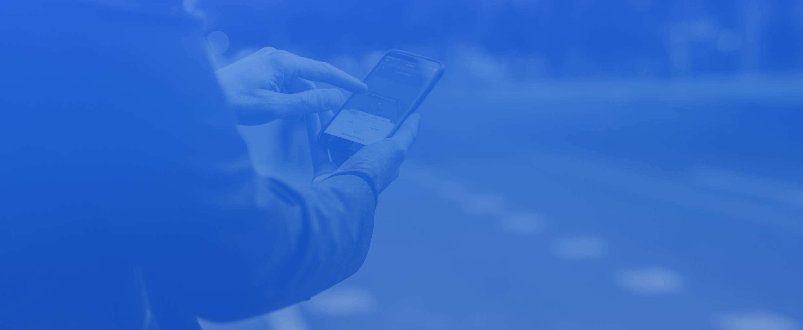 Person looking at rideshare app on phone