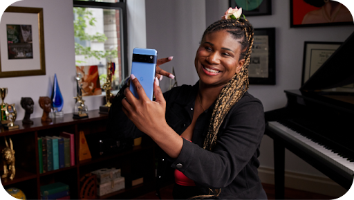 Woman taking selfie with Android phone.